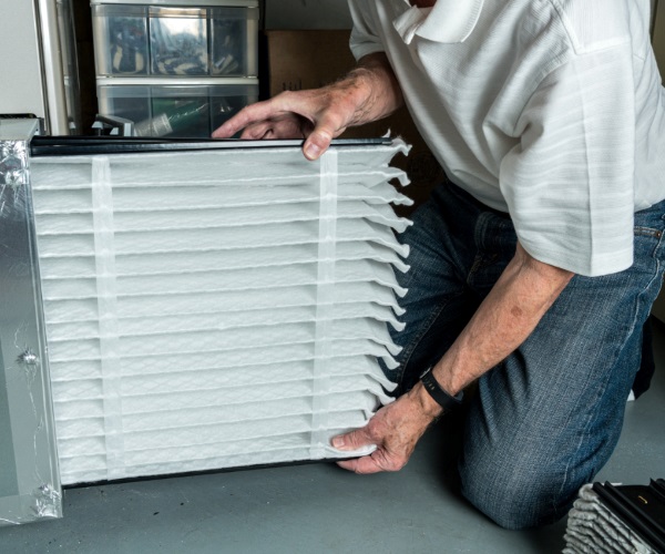 hvac technician replacing an air filter