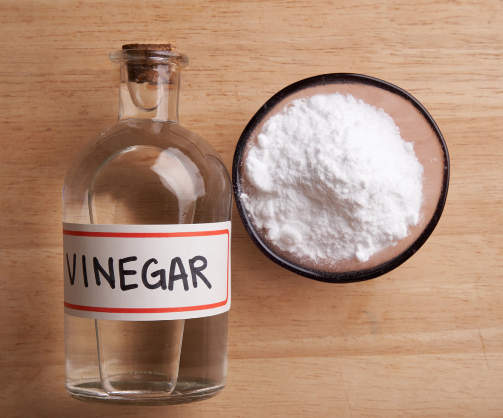 a bottle of clear vinegar on a wooden countertop