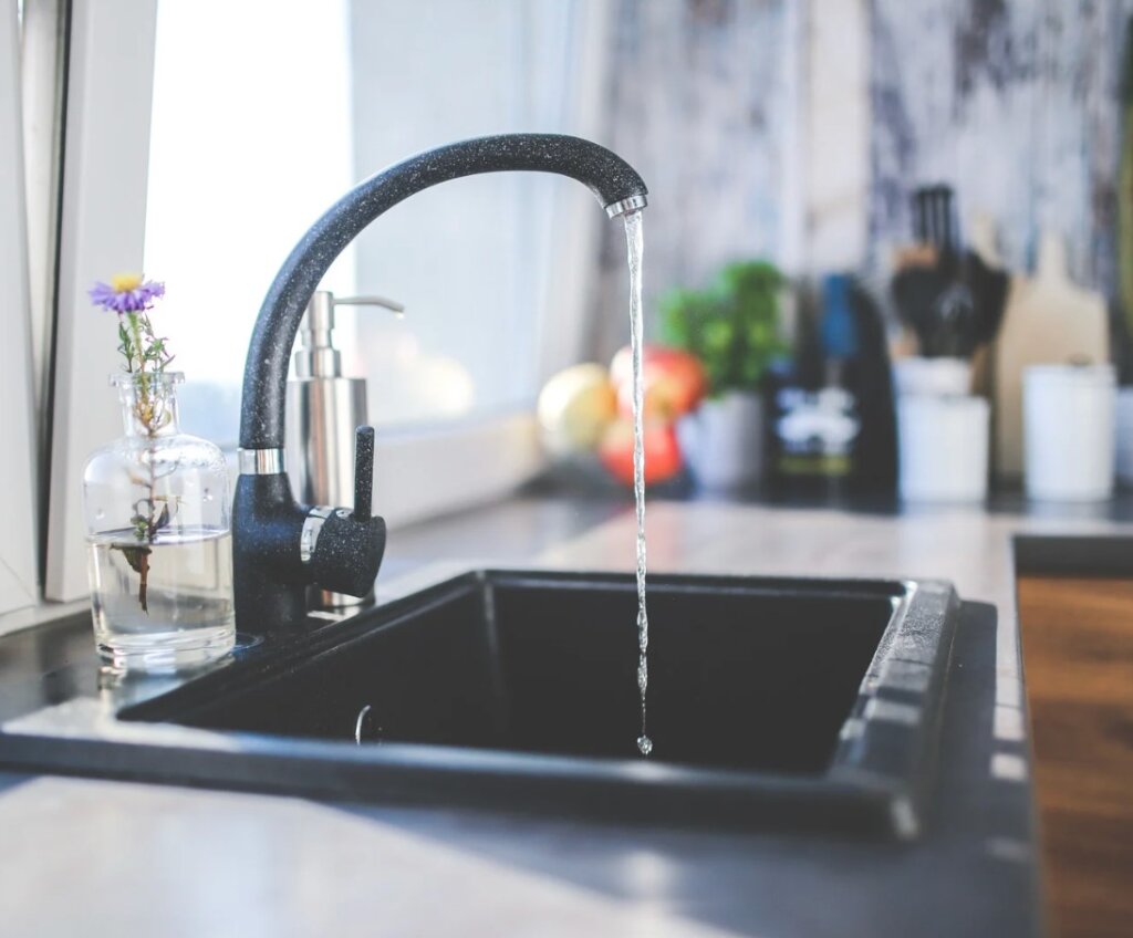 modern black faucet with running water