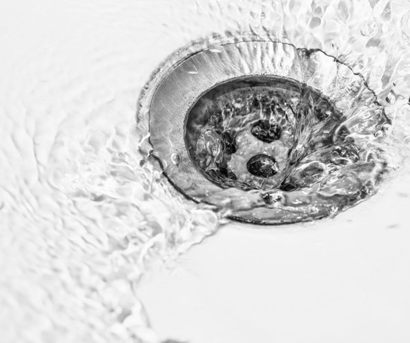 clean water going down a sink drain