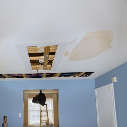 white ceiling with large spots of water damage